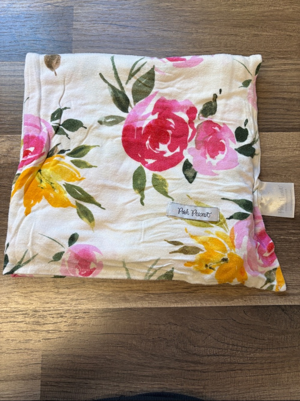 Posh Peanut swaddle blanket features a vibrant watercolor floral print